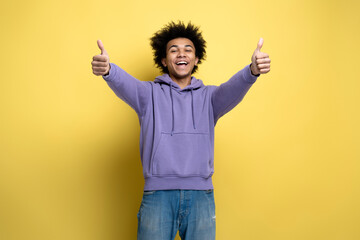 Handsome smiling African American man showing thumbs up gesture