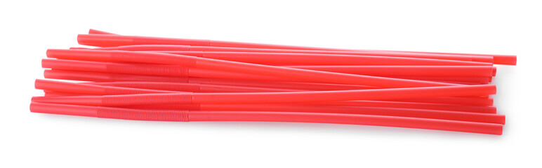 Red plastic cocktail straws on white background