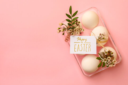 Flat lay composition with eggs, natural decor and phrase Happy Easter on pink background. Space for text