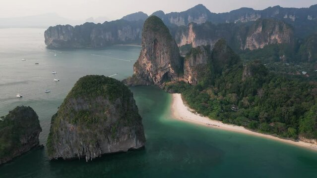 Scenic beach for summer holidays vacation, aerial drone video footage from drone Thailand, Mountains and sea water and sandy coastline. The most popular beach in Krabi, Thailand - Railay beach