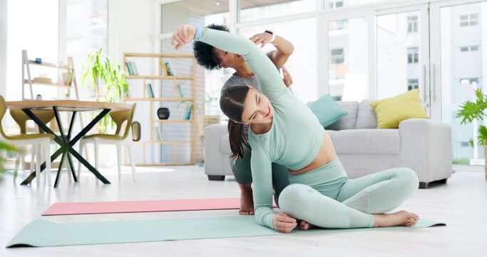 Yoga coach, women and stretching in home living room for health, wellness and fitness. Girls training, pilates and black woman or personal trainer helping female yogi with arm stretch for exercise.