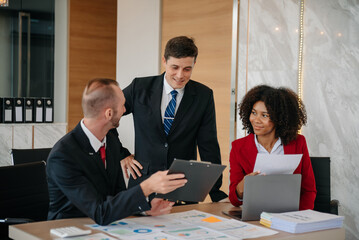 Group of young business people discussing business plan at modern startup in creative business discussing work modern office building.