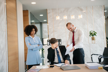 Team thinking of problem solution at office meeting, sad diverse business people group shocked by bad news, upset colleagues