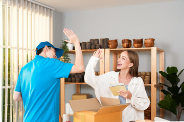Asian delivery man and Caucasian owner woman they are partner and tag team when success service order to customer at home office