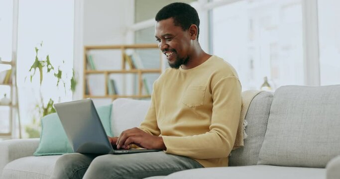 Typing, laptop and black man on sofa working on online report, research and internet blogging. Communication, remote work and happy male type on computer to browse website, writing email and busy