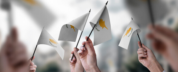 A group of people holding small flags of the Cyprus in their hands