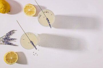 Still life with lavender infused lemonade and lemons on the white table - obrazy, fototapety, plakaty