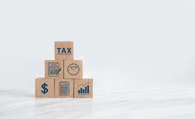 Wooden block with tax icon. Calculation tax return, vat, personal income tax, tax payment. Business and finance concept.