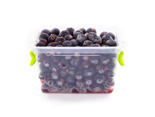 Container with frozen black currant.