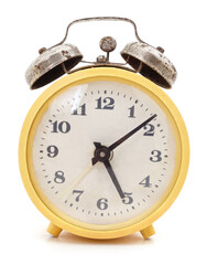 Old yellow alarm clock.