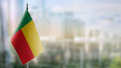 Small flags of the Benin on an abstract blurry background - obrazy, fototapety, plakaty