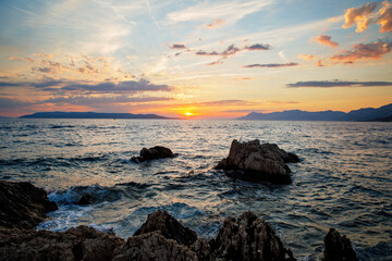 Amazing beach sunset with endless horizon and incredible foamy waves.