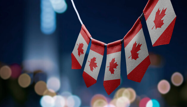 A garland of Canada national flags on an abstract blurred background