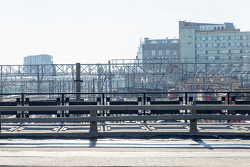 Naklejka premium Lots of railway tracks with standing trains on a sunny day against a blue sky in an industrial city. Top view.