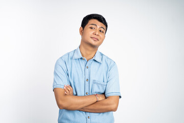 portrait of young asian man stand with crossed hands on isolated background