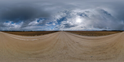 spherical 360 hdri panorama on gravel road with clouds on overcast sky in equirectangular seamless projection, use as sky replacement in drone panoramas, game development as sky dome or VR content