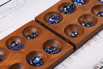 Mangala game board and glass marbles. Historical Turkish game mangala