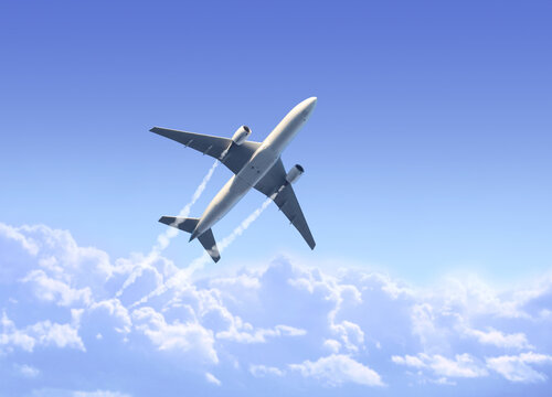 Horizontal nature background with aircraft and Jet trailing smoke in the sky. Airplane and condensation trail. Foggy trail jet and plane in blue sky with white clouds