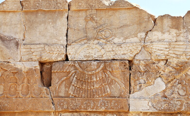 Ancient wall with bas-relief of Zoroastrian god Faravahar (Frahvahar), Persepolis, Iran. UNESCO world heritage site