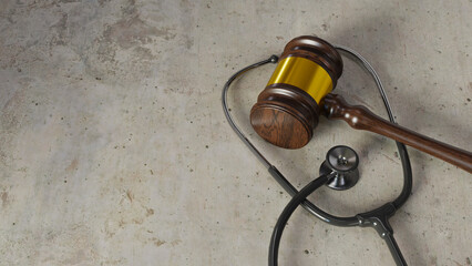 Medical dispute concept background with courtroom gavel and stethoscope, 3d rendering