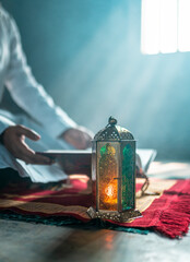 Muslim person praying with Quran , Traditional Ramadan Lantern lamp image