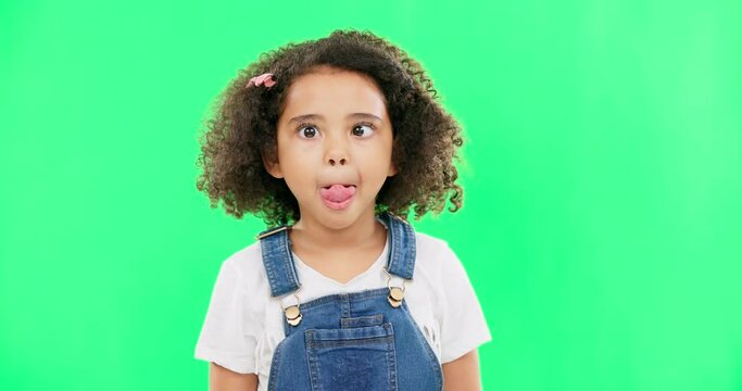 Little girl, silly and goofy face on green screen with facial expression against a studio background. Portrait of female child or kid making funny faces with tongue out for childhood youth on mockup