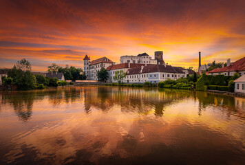 Jindrichuv Hradec castle at a sunset. Reflection in the water. Czech Republic.