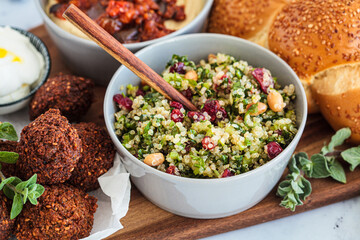 Quinoa salad with cranberry, nuts and celery. Israeli food concept.