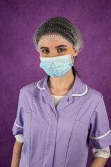 female doctor or nurse isolated on a plain background with a stethoscope around her neck.
