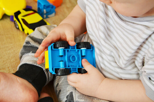 A boy plays a toy car