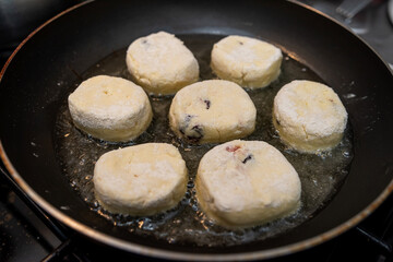 fresh tasty cheese pancakes cheesecakes are fried in a pan, ukraine traditional food