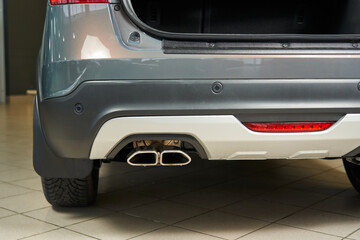 car rear bumper with fog lamp, parking sensors and exhaust pipe
