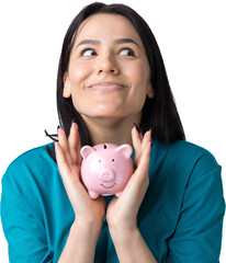 The girl holds a pink piggy bank and a coin in her hands. The concept of wealth and accumulation.