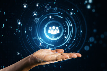 Close up of businessman hand using glowing people icons hologram. Creative global structure networking and data exchanges customer connection on dark background.