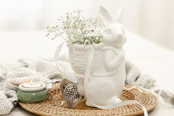 Easter composition with a ceramic hare and gypsophila flowers.