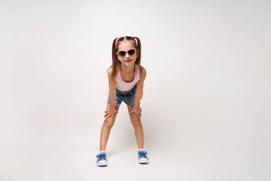 Cute little girl wearing denim shorts and top, white background © Gecko Studio