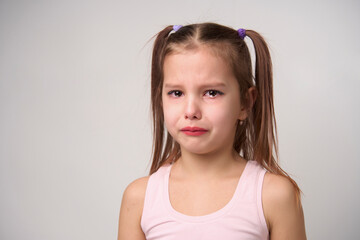 Crying child girl against white background
