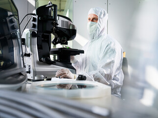 Technician using microscope working in laboratory