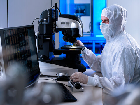 Engineer examining microscope in laboratory