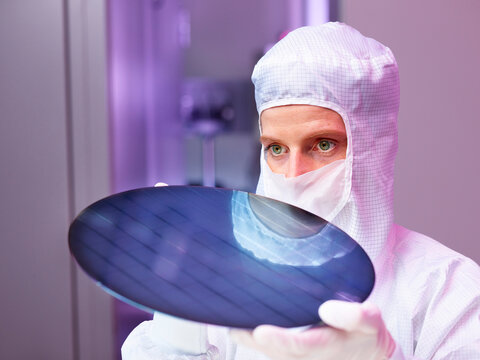 Engineer examining wafer chip in laboratory