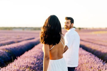 Woman walking with man in lavender field