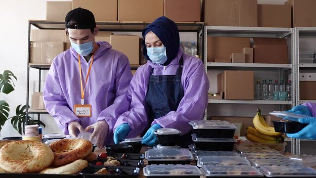 Muslim kitchen volunteers prepare and distribute hot iftar takeaway dinners in the month of Ramadan