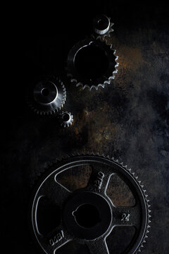 Metal gears lying on dark surface
