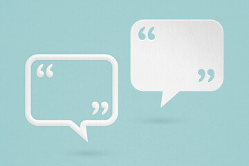 Conceptual image about communication and social media, customer feedback, white and white frame speech bubble and quote sign grunge paper cut on grunge blue background