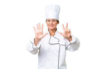 Middle-aged chef woman over isolated background counting eight with fingers