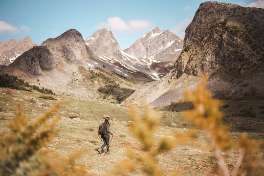 Woman hiking in Pyrenees on vacation, Selva de Oza, Huesca, Spain.