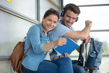 Fototapeta na wymiar couple woman holding book sitting at train platform