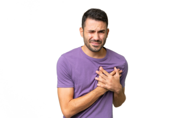 Young handsome caucasian man over isolated background having a pain in the heart