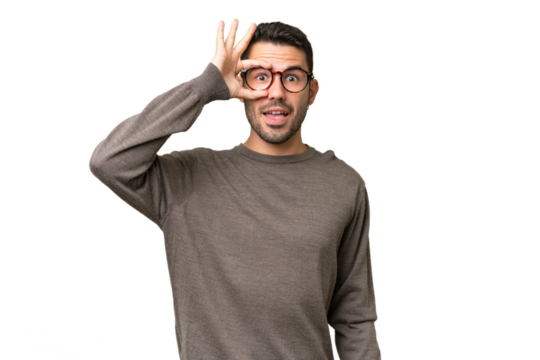 Young handsome caucasian man over isolated background showing ok sign with fingers