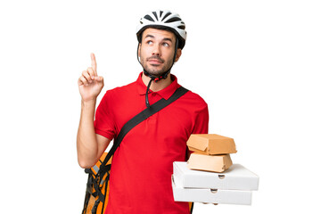 Young handsome caucasian man with thermal backpack and holding takeaway food over isolated background thinking an idea pointing the finger up